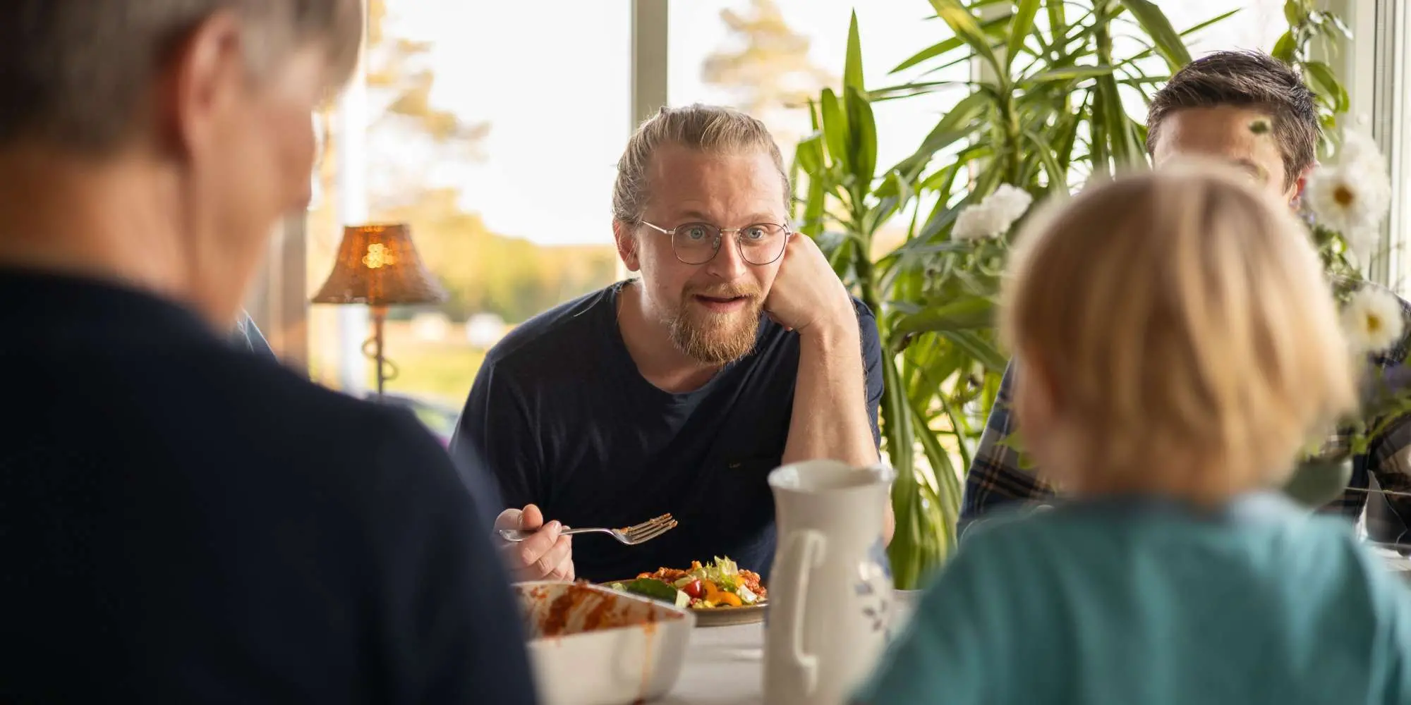 Man och barn pratar vid middagsbordet